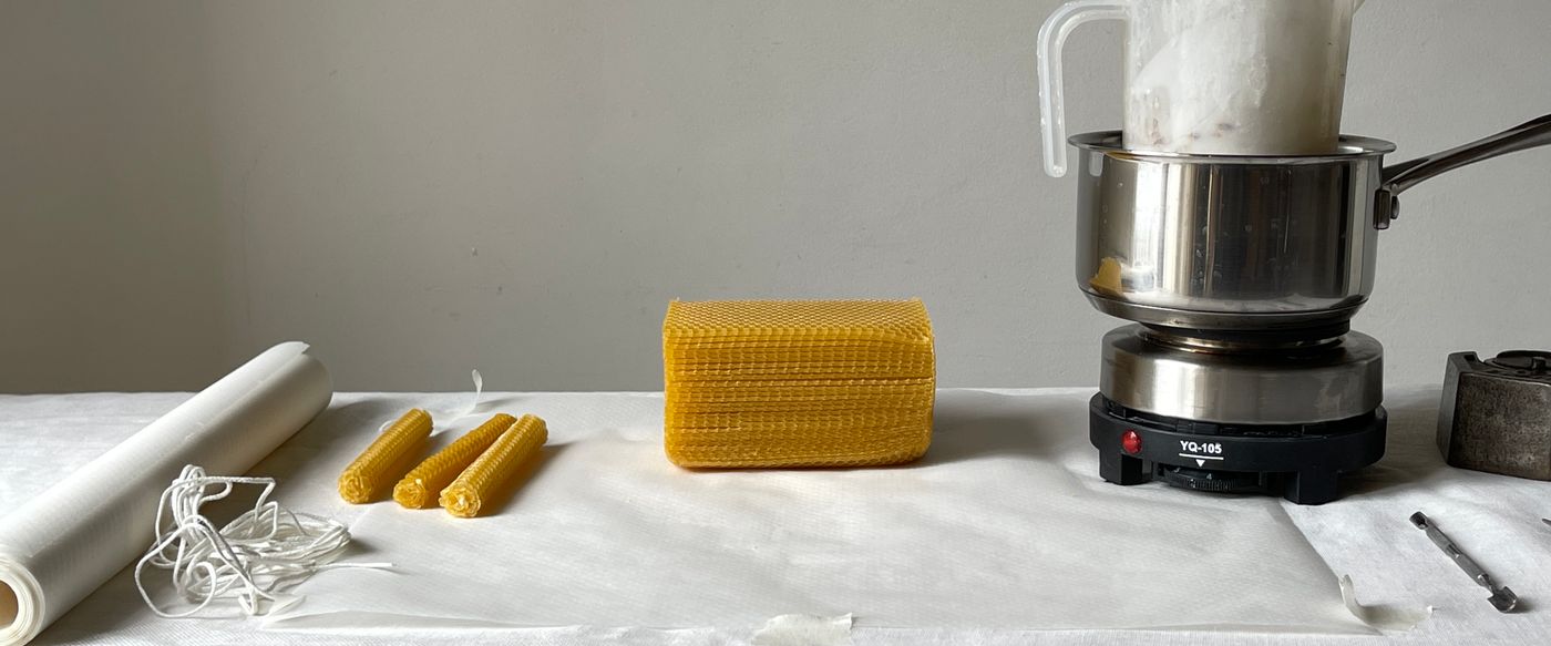 Candle making tools and melted wax laid out on a table, the craft behind candle fragrance